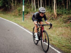 Cyclists Cut Through The Air on a Road Bike