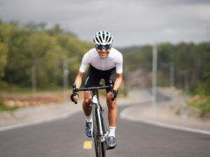 Road biker happily speeding on the track