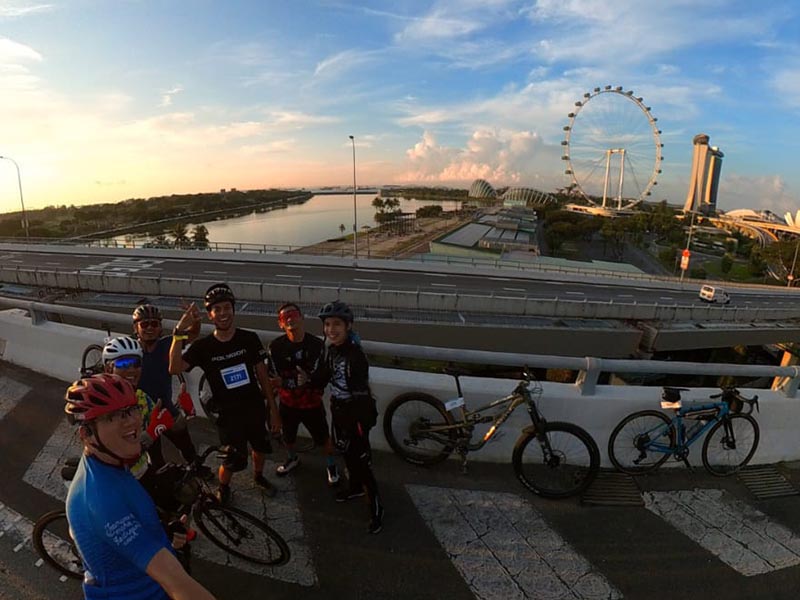 Cyclists enjoy the OCBC Cycle event by taking a group photo with Marina Bay Sands as the background