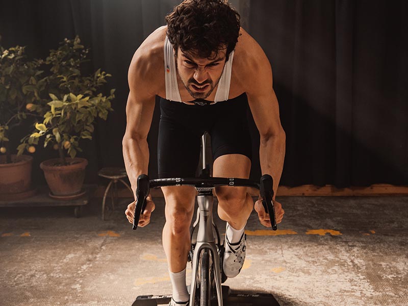 A road cyclist is doing indoor cycling training.