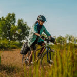 A Gravel cyclist riding through the grass tracks