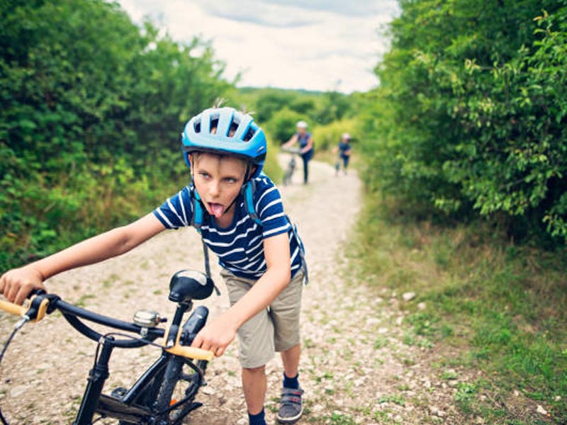 A boy got exhausted after riding a kids bike