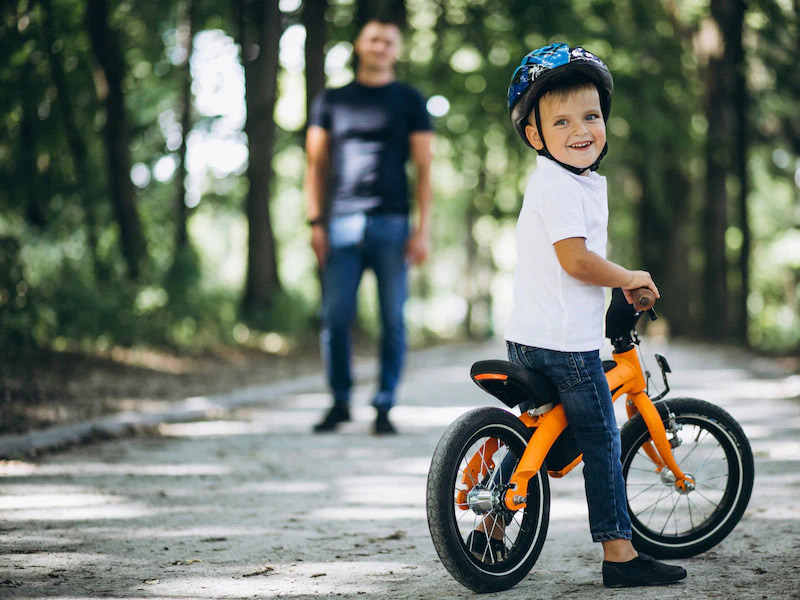 A child is ready to ride his push bike