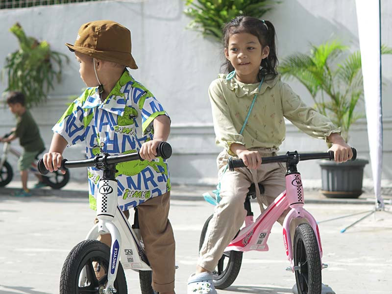 Riding a push bike together with friends