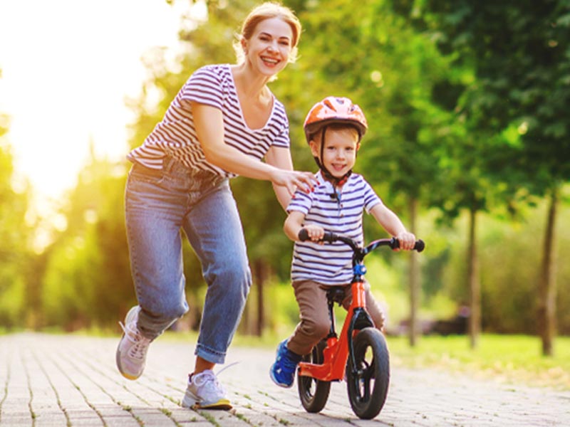 Riding a kids bike with the parent’s assistance