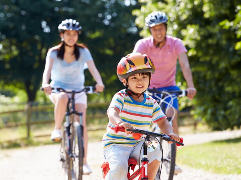 Cycling using a kids bike with parents
