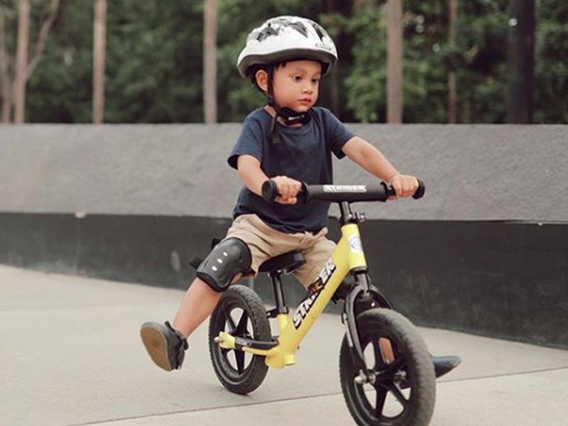 A boy learning a kids balance bike