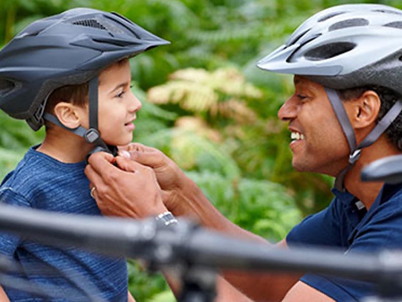Wearing a bicycle helmet before playing with a kids mountain bike